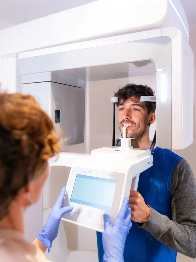 vertical-photo-rear-view-technician-using-x-ray-dental-machine-with-patient